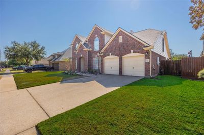 This charming home features a two-car garage, perfect for all your storage needs | Image 2