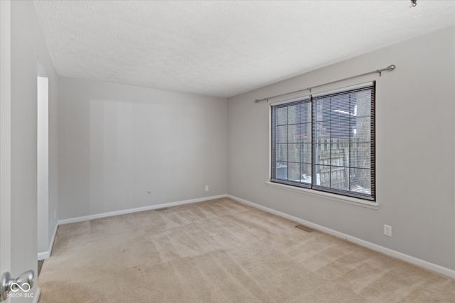 unfurnished room with carpet and a textured ceiling | Image 12