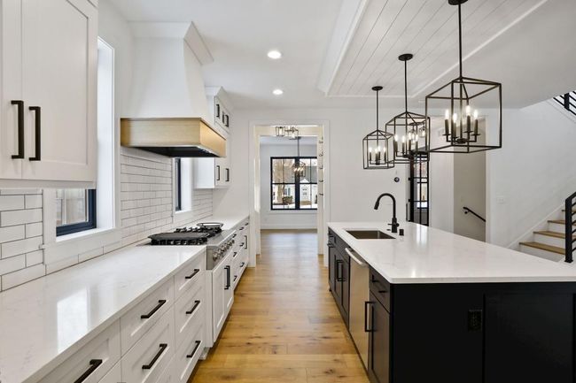 Large central island is great to gather around! Pictures of previously built house. | Image 10