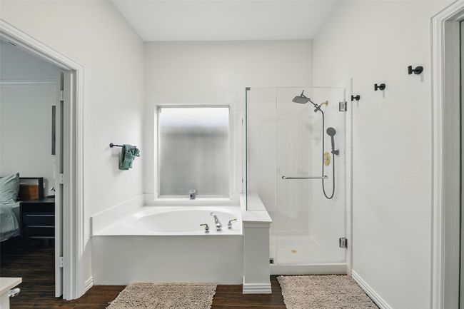 Bathroom with wood finished floors, a shower stall, and a garden tub | Image 21