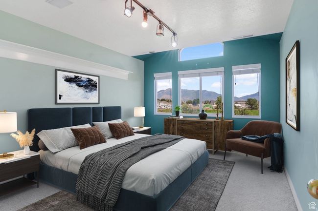 Carpeted bedroom featuring rail lighting, a mountain view, and visible vents | Image 12