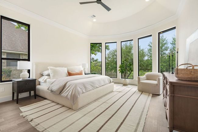 The main-level primary suite offers a serene escape, with generous dimensions that comfortably accommodate a king bed, seating area, and more. | Image 15