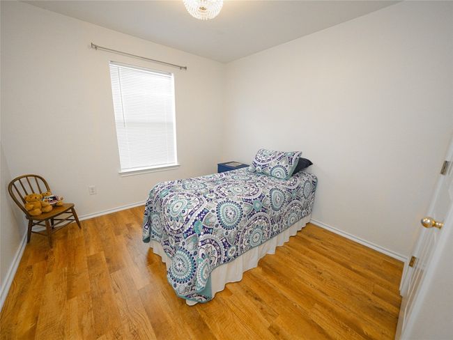 Bedroom with light wood-type flooring and baseboards | Image 20