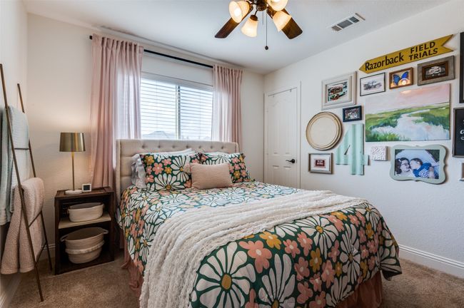 Another secondary bedroom with backyard views, ceiling fan, good closet size! First floor offers three bedrooms and two baths. Let's go look upstairs! | Image 13