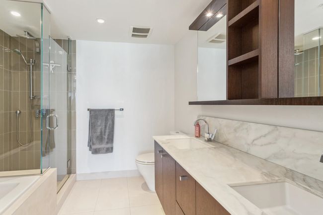 Bathroom with a sink, visible vents, a stall shower, toilet, and tile patterned floors | Image 16