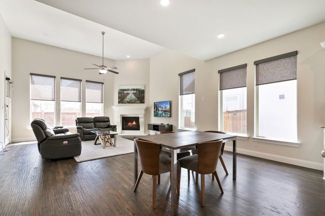 Dining room with baseboards, a lit fireplace, recessed lighting, and dark wood finished floors | Image 15