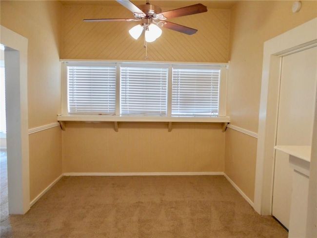 Spare room featuring ceiling fan, carpet, and a smoke detector | Image 5