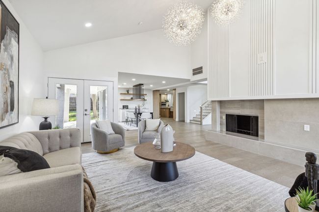 Living room with visible vents, recessed lighting, a fireplace with raised hearth, and wood finished floors | Image 6