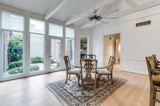 Dining room featuring light wood finished floors and ceiling fan | Image 12