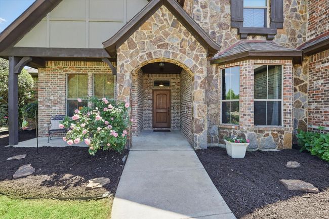 Doorway to property featuring stone siding and brick siding | Image 5