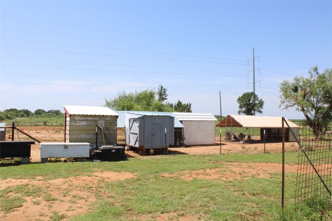 View of yard with a carport, exterior structure, and an outdoor structure | Image 19