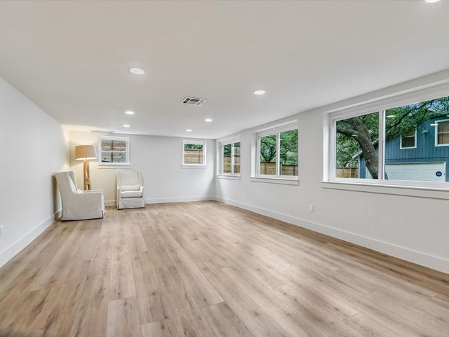 Unfurnished room with light wood-style floors, a wealth of natural light, and visible vents | Image 9