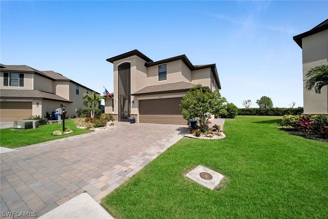 View of front of home featuring a garage and a front lawn | Image 1