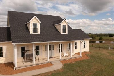 View of front of property with a front yard and a patio | Image 1