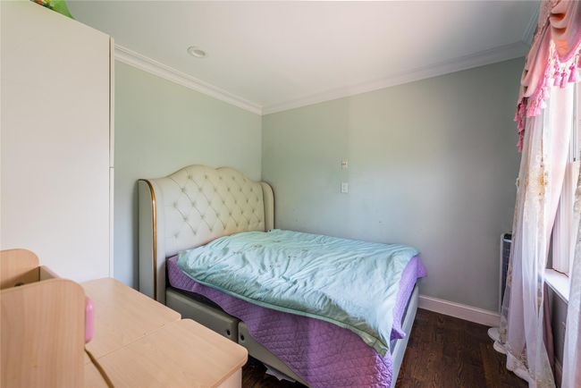 Bedroom featuring crown molding, wood finished floors, baseboards, and recessed lighting | Image 23