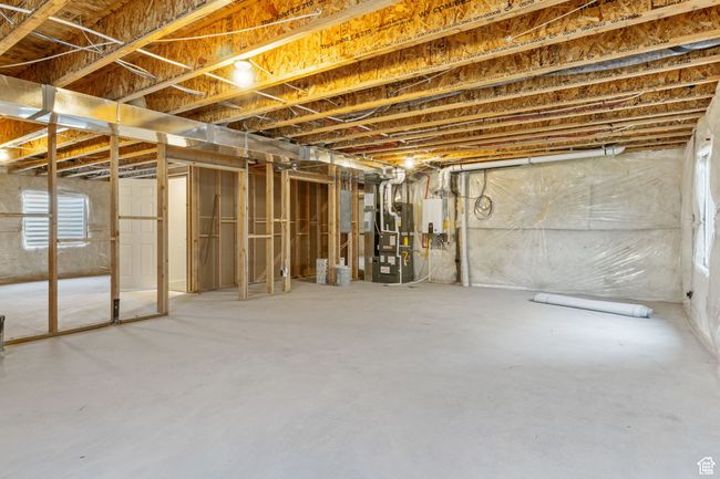 Below grade area featuring electric panel and heating unit | Image 11