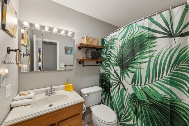 Full bathroom with ample storage and bright lighting. | Image 52