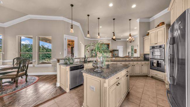 Kitchen with a peninsula, appliances with stainless steel finishes, cream cabinetry, and ceiling fan | Image 17