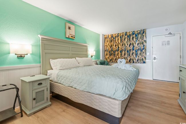 Bedroom with wainscoting and light wood finished floors | Image 4