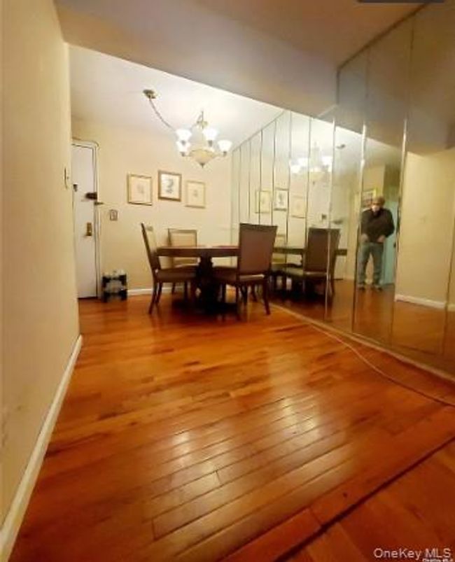 Dining space with hardwood / wood-style floors and a chandelier | Image 17