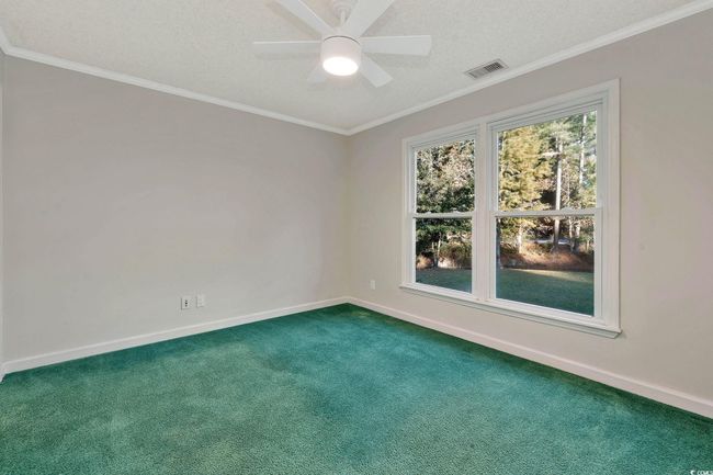 Empty room with crown molding, carpet, and ceiling fan | Image 14