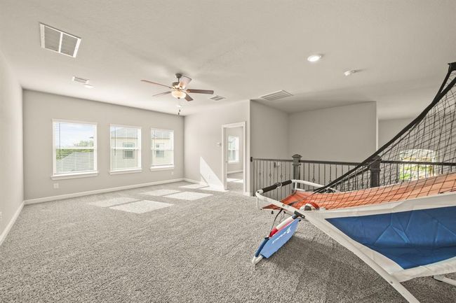 Flexible upstairs loft area ideal for play, study, or an additional media space. | Image 25
