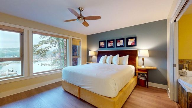 Bedroom with baseboards, light wood-style floors, and ceiling fan | Image 19