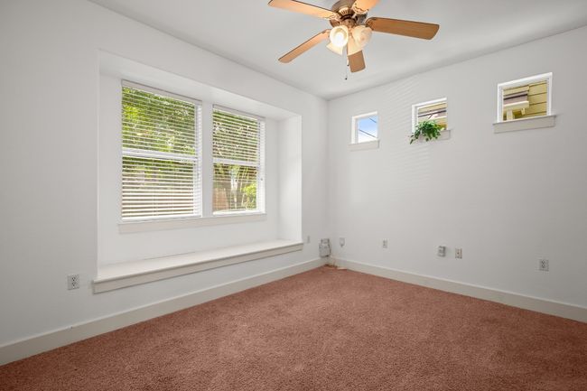 Spare room with carpet flooring, baseboards, and a ceiling fan | Image 17