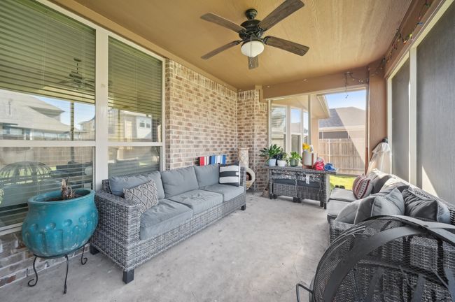 Sunroom featuring an outdoor living space and a ceiling fan | Image 33