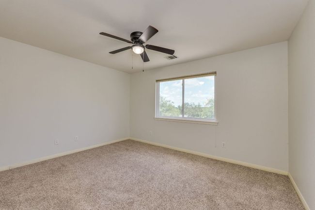 Carpeted spare room with ceiling fan and baseboards | Image 28