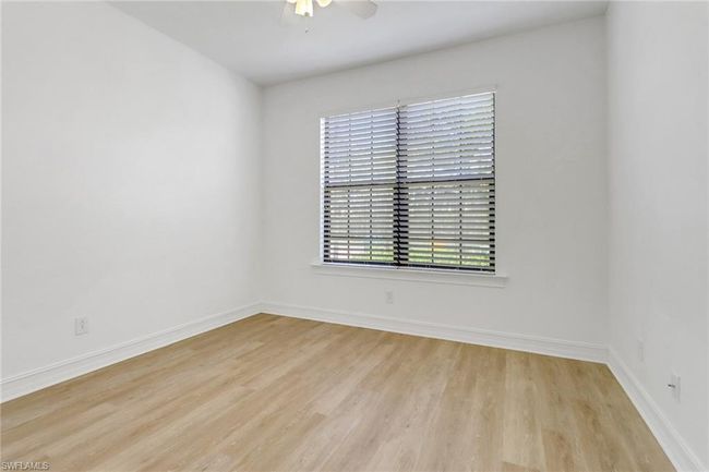 Empty room featuring wood finished floors, a ceiling fan, and baseboards | Image 12