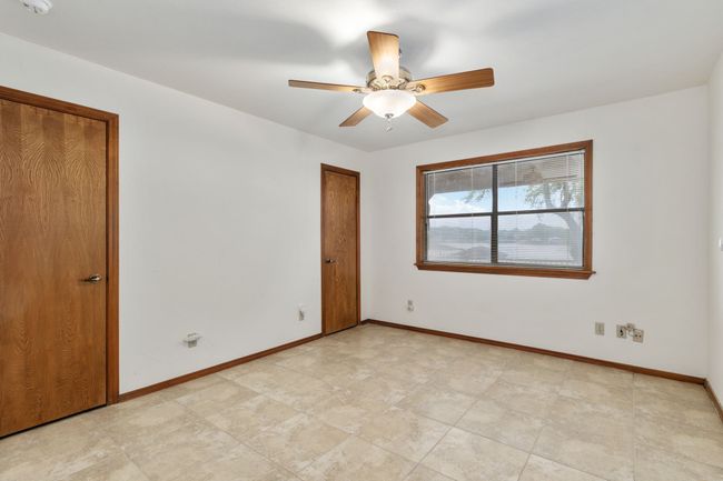 Unfurnished bedroom with baseboards and a ceiling fan | Image 29
