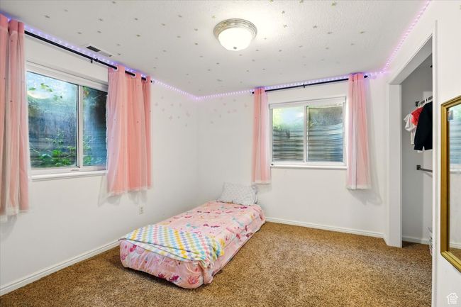 Carpeted bedroom with baseboards | Image 25