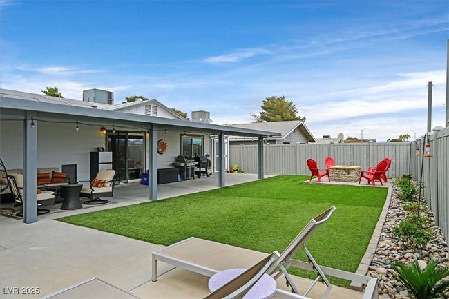 View of yard with a patio, a fenced backyard, and an outdoor fire pit | Image 28