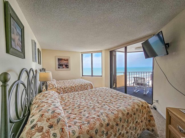 Carpeted bedroom featuring access to exterior and a textured ceiling | Image 28