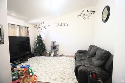 Living room featuring carpet floors and vaulted ceiling | Image 3