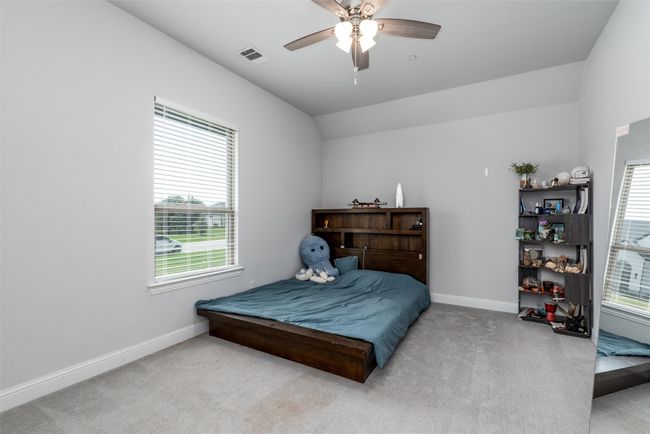Bedroom with carpet, baseboards, multiple windows, and vaulted ceiling | Image 20