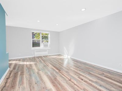 Spare room featuring light hardwood / wood-style flooring and radiator heating unit | Image 2