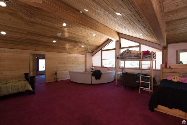 Bedroom featuring wood ceiling, carpet, and multiple windows | Image 65