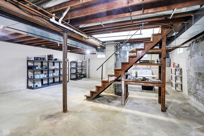 unfinished below grade area featuring stairs and electric panel | Image 21