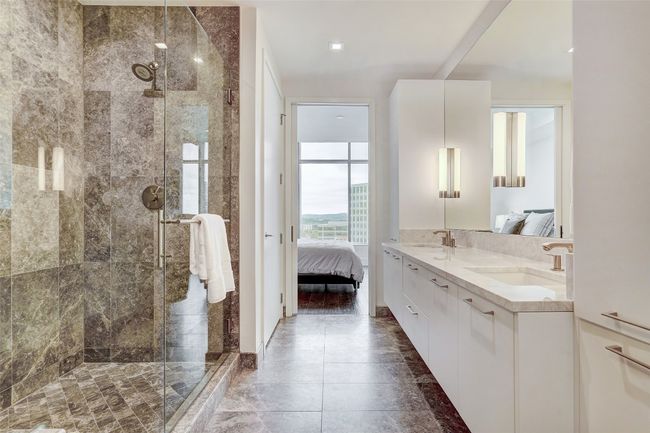 Ensuite bathroom featuring double vanity, a shower stall, and tile patterned floors | Image 18