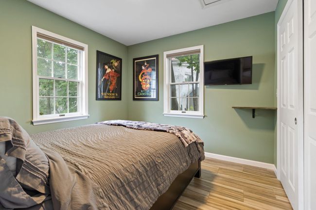 Bedroom with baseboards, a closet, and light wood-style flooring | Image 7