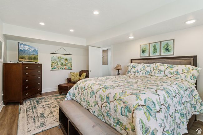 Bedroom featuring wood finished floors and recessed lighting | Image 32