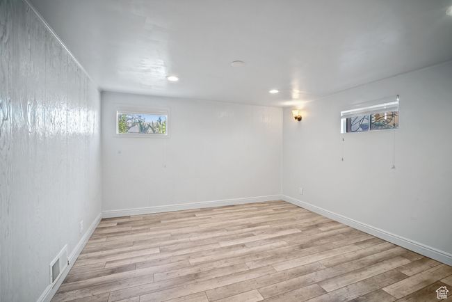Below grade area with light wood finished floors, recessed lighting, and baseboards | Image 20
