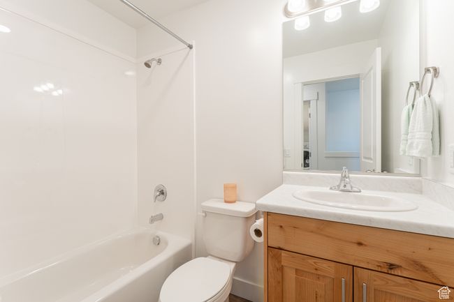 Full bathroom with bathing tub / shower combination, vanity, and toilet | Image 16