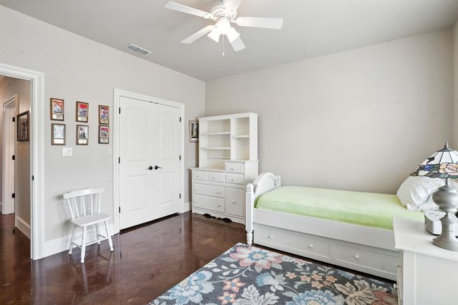 Bedroom with ceiling fan, a closet, and finished concrete floors | Image 24