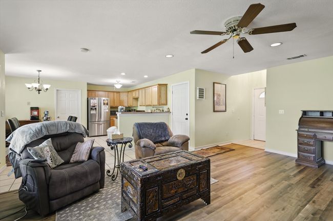 Living area featuring recessed lighting, visible vents, ceiling fan with notable chandelier, and baseboards | Image 7