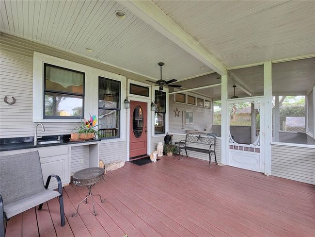 Experience exceptional outdoor living on the spacious covered patio, complete with a sink and cabinets for seamless entertaining. | Image 31