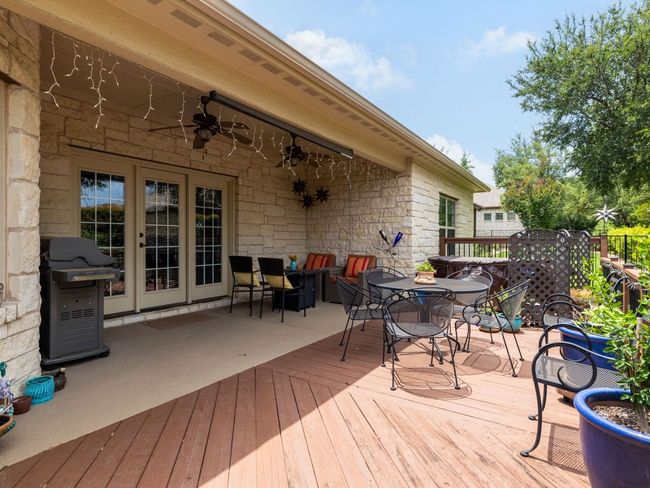 Deck featuring outdoor dining space, a ceiling fan, and area for grilling | Image 23