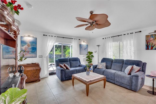 Sliding doors lead out to the screened in patio. | Image 5